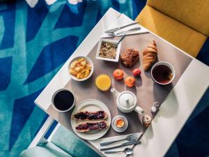 a table with breakfast foods and drinks on it at Mercure Toulouse Centre Saint-Georges in Toulouse
