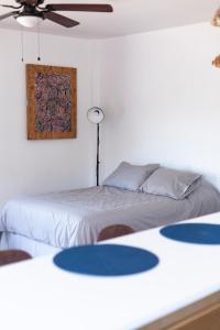 a bedroom with two beds and a ceiling fan at Coyote Lofts-Estacion Federal in Tijuana