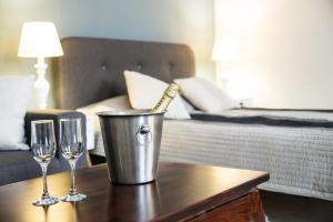 a bottle of champagne in a bucket on a table with two glasses at Ultra central apartment in Cluj-Napoca