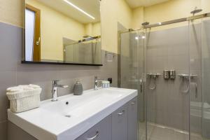 a bathroom with a sink and a glass shower at Spazio Seicentesco in Verona +52 photos
