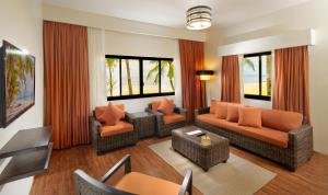 a living room with couches and chairs and windows at Oceanica Resort Panglao, Bohol in Panglao