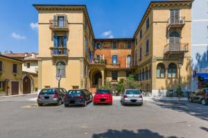 a group of cars parked in a parking lot in front of a building at Spazio Seicentesco in Verona