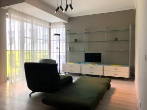 a living room with a couch and a television at Art Academy Apartment in Tallinn
