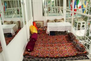 a room with two tables and a rug at Anvar's Guests in Tashkent