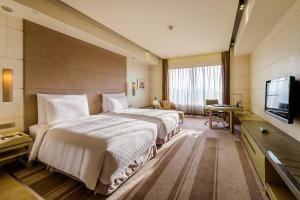Televiisor ja/või meelelahutuskeskus majutusasutuses Hotel Nikko Saigon