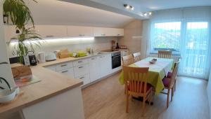 a kitchen with a table and chairs and a dining room at Garden Apartments Janša in Radovljica