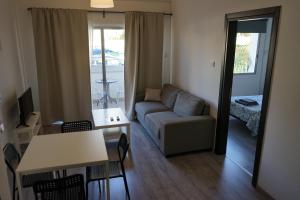 a living room with a couch and a table at Polyxeni Hotel Apartments in Limassol