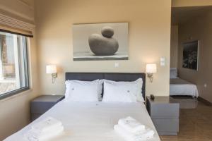 Posteľ alebo postele v izbe v ubytovaní Marini Luxury Apartments and Suites
