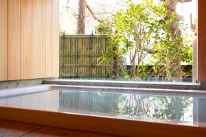 a swimming pool in front of a window at Kamakura COCON in Kamakura