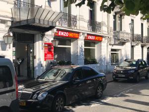 a black car parked in front of a building at Enzo Hotels Contrexeville in Contrexéville +11 photos
