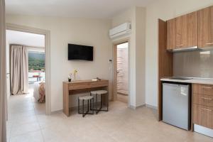 a kitchen with a counter and a table and chairs at Astra Sarti Luxury Suites in Sarti