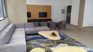 a living room with a couch and a table at Island Living at One Manchester Place in Mactan
