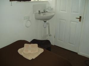 a bathroom with a sink and a sink at The Old Forge Seafood Restaurant and Bed and Breakfast in Thursford