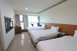 Yi Dian Yuan Hotel tesisinde bir odada yatak veya yataklar