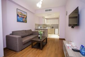 a living room with a couch and a table at Welcome Yerevan Apartments in Yerevan