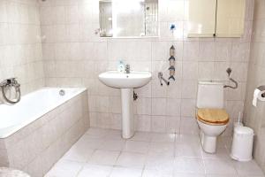 a bathroom with a sink and a toilet and a bath tub at Victoria's Apartment in Thessaloniki +13 photos