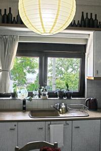 a kitchen with a sink and a window at Victoria's Apartment in Thessaloniki