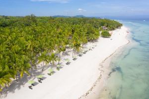 an aerial view of a beach with chairs and palm trees at Oceanica Resort Panglao - formerly South Palms Resort Panglao in Panglao