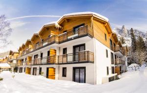 a building in the snow with snow covered ground at Résidence Odalys Isatis in Chamonix +122 photos