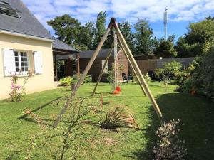 a swing set in the yard of a house at Maison proche bord de mer in Guissény