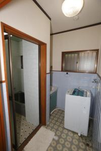 a bathroom with a shower and a toilet and a tub at LAZYHOUSE 別邸 in Okayama +15 photos