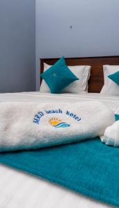 A bed or beds in a room at MRD Beach Hotel