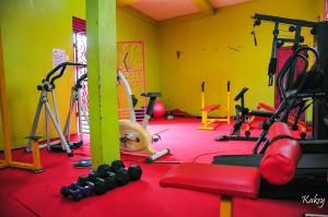 a gym with a bunch of equipment in a room at Dreamz Recreation Center in Jinja