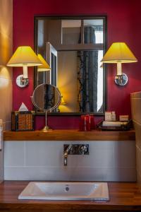 a bathroom with a sink and a mirror at Royal Emeraude Dinard - MGallery in Dinard