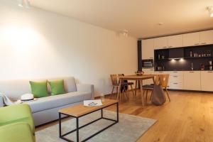 a living room with a couch and a table at All-Suite Resort Ötztal in Oetz