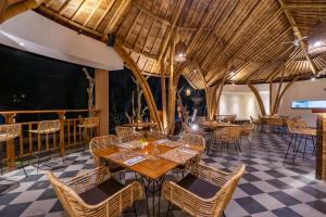 a restaurant with tables and chairs and a large ceiling at Villa Sonia Bisma in Ubud