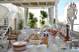 a buffet line with plates of food on a table at Palazzo Mosco - Dimora Storica in Gallipoli