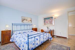 a bedroom with a bed with a blue bedspread at CANDIANO Cruise-Port in Venice