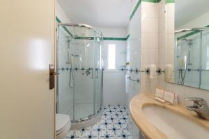 a bathroom with a shower and a sink and a toilet at Hotel Continental Ischia in Ischia