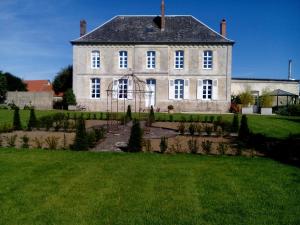 a large house with a garden in front of it at Charme D Antan in Villers-Châtel
