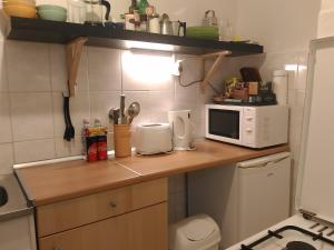 a kitchen with a wooden counter top with a microwave at Danube river view close to Parlament in Budapest