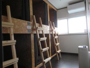 a room with four wooden ladders leaning against a wall at Pirka Sapporo in Sapporo