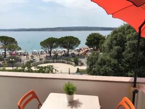 a balcony with a table and a view of the water at Apartment Romeo in Crikvenica