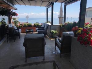 a patio with chairs and tables and a view of the ocean at Dilhayat Kalfa Hotel in Istanbul