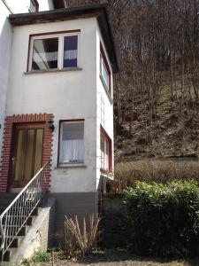 a white house with a staircase in front of it at Haus an der Diemel in Diemelsee