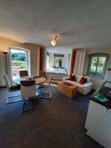 a living room with a couch and a table at Plantagengut Hosterwitz in Dresden