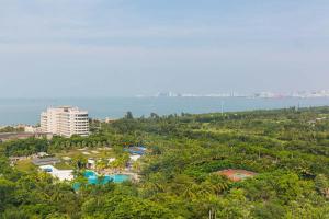 an aerial view of a resort with the ocean in the background at Haikou Xiuying·Binhai Avenue· Locals Apartment 00164510 in Changliu