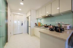 a kitchen with white cabinets and a counter top at Dalian Shahekou·Peace Square· Locals Apartment 00162860 in Dalian