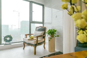 einen Stuhl in einem Zimmer mit Fenster in der Unterkunft Chengdu Dujiangyan·DuJiangYan· in Chengdu