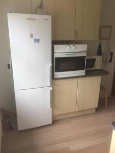 a kitchen with a white refrigerator and a microwave at Bramming city privat overnatning , ingen morgenmad in Bramming