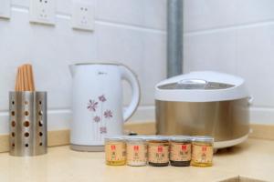 a kitchen counter with jars of spices next to a processor at Baoding Lianchi·North China Electric Power University· in Baoding
