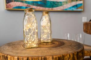 duas garrafas de vidro com luzes numa mesa de madeira em Zhengzhou Jinshui · North 3rd Ring Huayuan Road·Locals Apartment · 00174560 em Zhengzhou