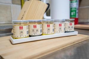 a group of jars of food sitting on a shelf at Zhengzhou Jinshui · North 3rd Ring Huayuan Road·Locals Apartment · 00174560 in Zhengzhou +16 photos