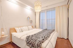 Un pat sau paturi într-o cameră la Qingyang Wenshuyuan· Chengdu