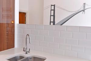 a kitchen sink with a bridge on the wall at Gresham 1-bed in Eastbourne