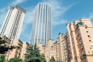 a group of tall buildings in a city at [Roader] Wuhan Jianghan District, Xinhua Road in Wuhan